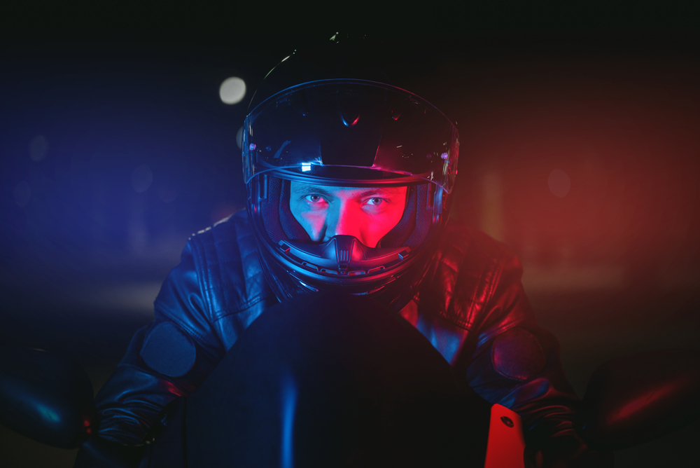 Motorcyclist riding at night in winter conditions highlighting reduced visibility risks in New Jersey
